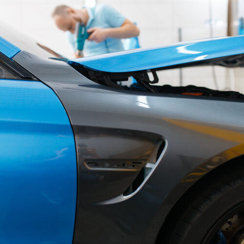 Car wrapping, protective foil or film coating Car wrapping, protective vinyl foil or film coating on the vehicle, nobody. Auto detailing. Automobile paint protection, professional tuning